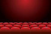 Empty cinema with red seats on a dark background