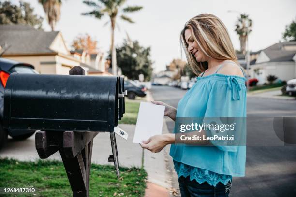 woman checking mailbox - postbox stock pictures, royalty-free photos & images