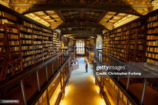 Front of House Visitor Host Jessica Baudet wears protective mask and shield as she stands in the Duke Humphrey’s Library at the Bodleian Libraries on...