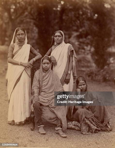 Four Hindu Women, One Seated in a Chair, Outdoors, 1860s-70s. Artist Unknown.