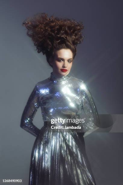 beautiful woman in sparkly silver outfit - silver dress stock pictures, royalty-free photos & images