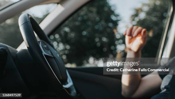 soft focus background image of a man behind the steering wheel, waiting in a stationary car. - turning key stock pictures, royalty-free photos & images