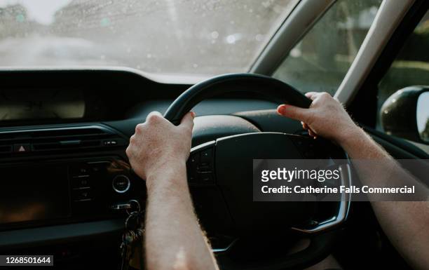 man grips steering wheel with two hands - drivers license stock pictures, royalty-free photos & images