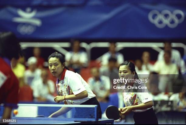 Yaping Deng of China and her Doubles partner in action against another Chinese team during the Women's Doubles Table Tennis event at the 1992 Olympic...