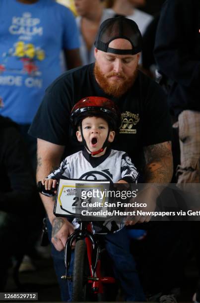 Year-old August Economu of Palmdale, Ca. Lets out a big yawn as he waits with his dad August at the starting line for the race to begin, during the...
