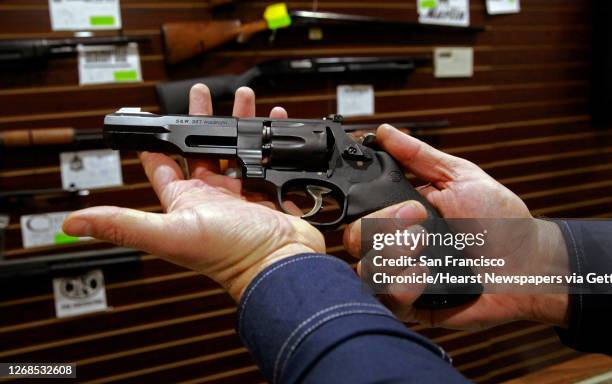 Customer displays the hand giuun he had purchased from Todd Settergren of Setterarms gun shop, on Friday Jan. 13 in Walnut Creek, Ca. Gun shop owner,...