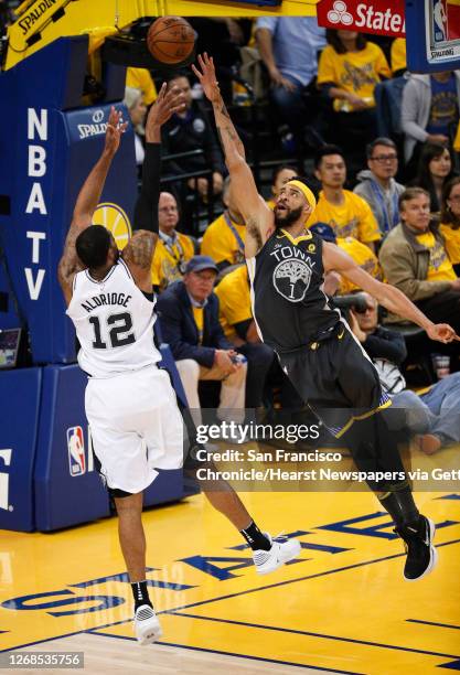 San Antonio Spurs' LaMarcus Aldridge shoots over Golden State Warriors' JaVale McGee in the first quarter during game 2 of round 1 of the Western...