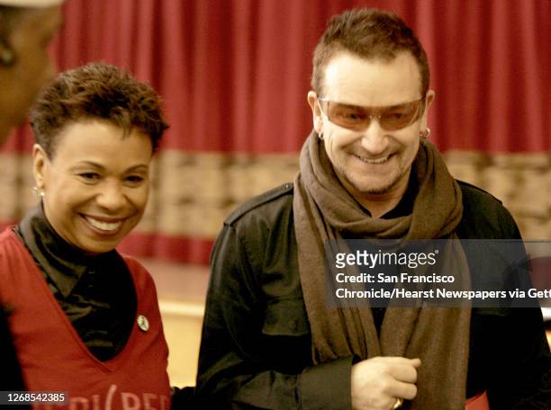 At Allen Temple Baptist Church, in Oakland, international AIDS activist and U2 lead singer , Bono and U.S. Rep. Barbara Lee leave the auditorium...