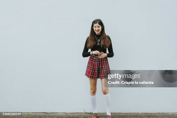 smiling girl in plaid mini skirt - girls in plaid skirts stock pictures, royalty-free photos & images