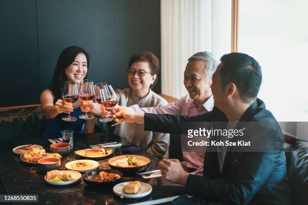 família asiática brindando para uma ocasião alegre - chinese mothers day - fotografias e filmes do acervo
