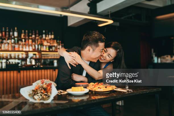 beautiful asian couple celebrating valentine's day or birthday in a restaurant - restaurant happy couple stock pictures, royalty-free photos & images