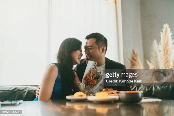 married asian couple dining and enjoying their conversations - private dining stock pictures, royalty-free photos & images