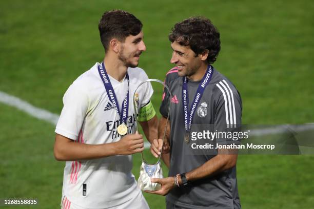 Victor Chust and Raul Gonzalez Blanco Head coach of Real Madrid pose with the trophy following the UEFA Youth League Final 2019/20 between SL Benfica...