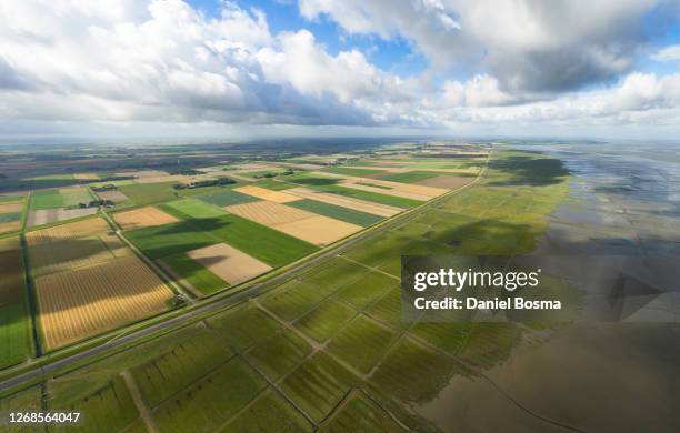 beautiful aerial view of the cultivated dutch coastline - llanura costera fotografías e imágenes de stock