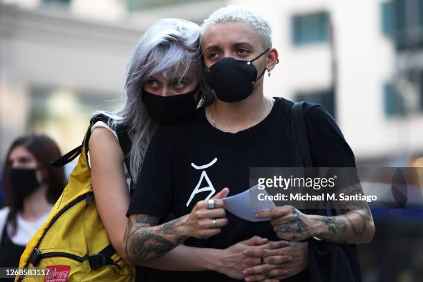 Couple embraces as they listen to speakers during a vigil for Jacob Blake on August 25, 2020 in New York City. The Wisconsin National Guard has been...