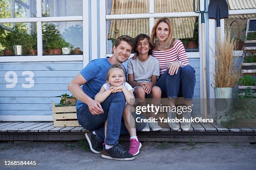 Happy family posing together outside the house Happy family posing together outside the house