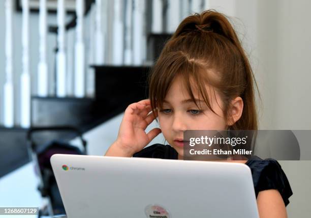 Goolsby Elementary School second grader Ella Dweck takes an online class at a friend's home during the first week of distance learning for the Clark...