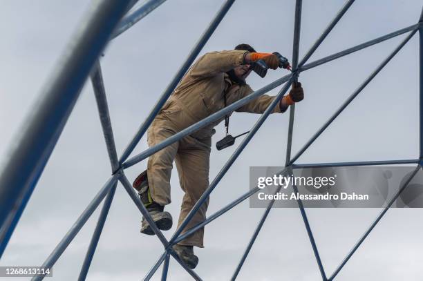 Detail of the Navy Officer finishing assembly of the dome structure in the area of the guests of the opening ceremony of the Comandante Ferraz...