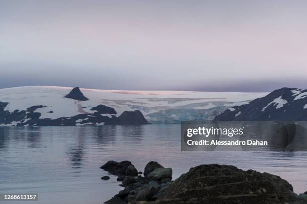 Sunset reflected on the Krak Glacier and Nunatak Tern on January 10, 2020 in King George Island, Antarctica.