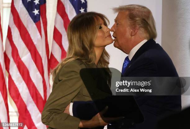 President Donald Trump kisses first lady Melania Trump after her address to the Republican National Convention from the Rose Garden at the White...