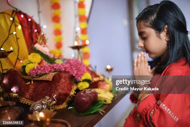 girl praying the hindu god lord ganesha - hindu religion stock pictures, royalty-free photos & images