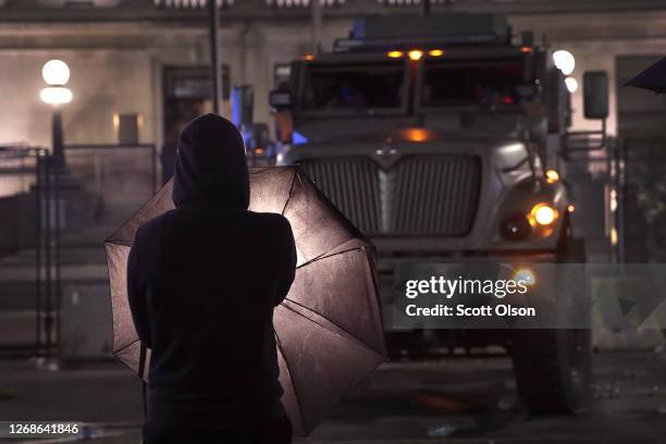 Demonstrators confront police in front of the Kenosha County Courthouse during a third night of unrest on August 25, 2020 in Kenosha, Wisconsin....