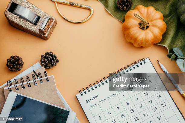 flat lay desktop with october calendar - october stock-fotos und bilder