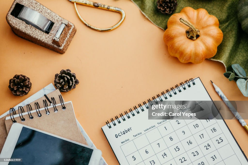 Flat lay desktop with october calendar