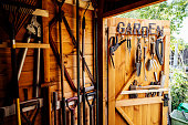 Interior of wooden gardening shed with neatly arranged tools