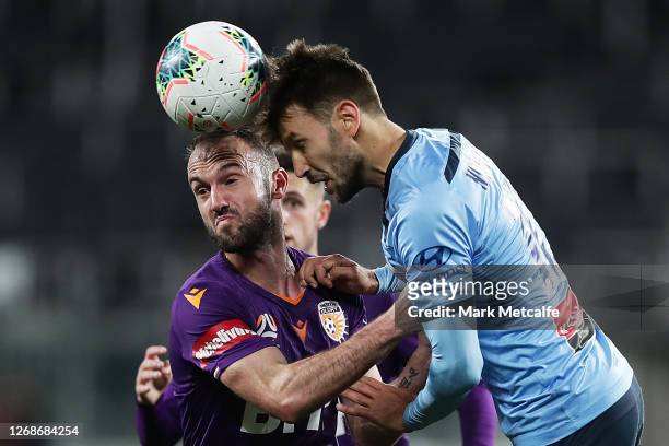 Milos Ninkovic of Sydney FC heads the ball as he is challenged by Ivan Franjic of the Glory during the A-League Semi Final match between Sydney FC...