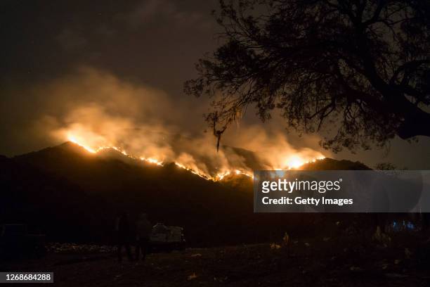 Local villagers observe wildfires from Casa Grande community on August 25, 2020 in Cordoba, Argentina. Wildfires are raging Argentina's Cordoba...