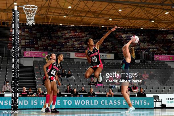 Layla Guscoth of the Thunderbirds attempts to block the shot from Tegan Philip of the Vixens during the round seven Super Netball match between the...