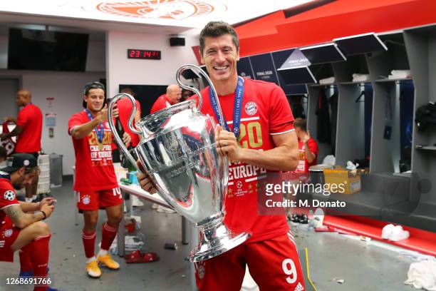 Robert Lewandowski of FC Bayern Muenchen poses with the trophy in the dressing room following his team's victory in the UEFA Champions League Final...