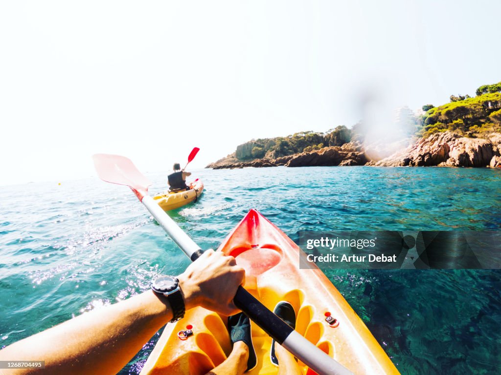 Doing kayak from personal perspective with friend in the beautiful hidden corners of Girona Costa Brava in Spain during summer of 2020.