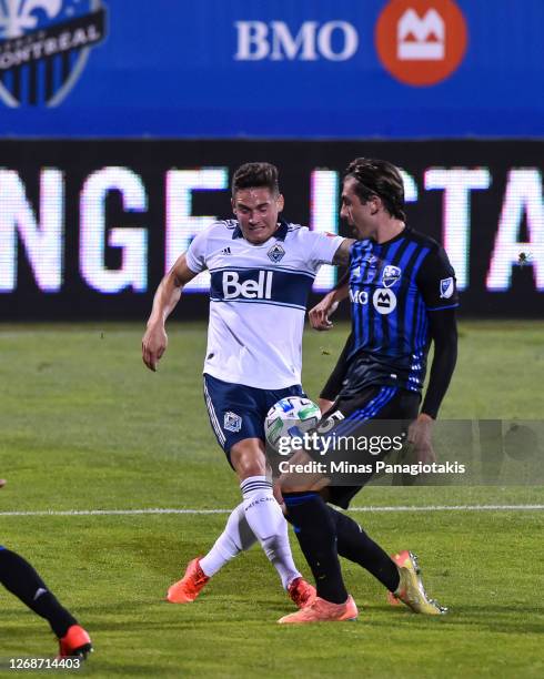 Jake Nerwinski of the Vancouver Whitecaps and Luis Binks of the Montreal Impact battle for the ball during the second half of the MLS game at Saputo...