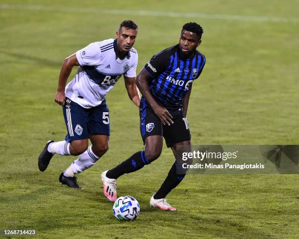 Orji Okwonkwo of the Montreal Impact controls the ball against Ali Adnan of the Vancouver Whitecaps during the second half of the MLS game at Saputo...