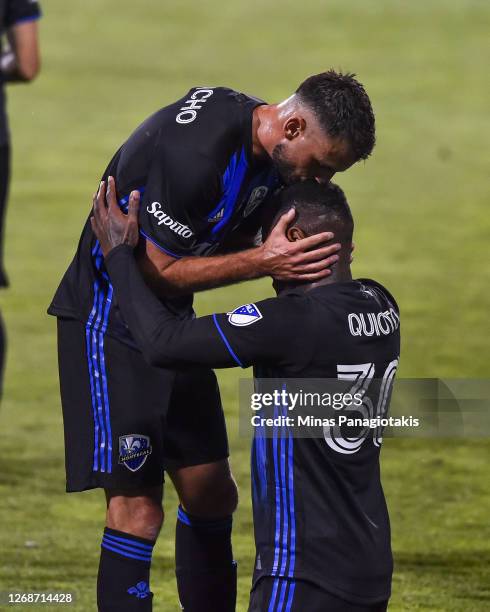 Romell Quioto of the Montreal Impact receives a kiss from teammate Rudy Camacho after scoring a goal during the first half of the MLS game against...