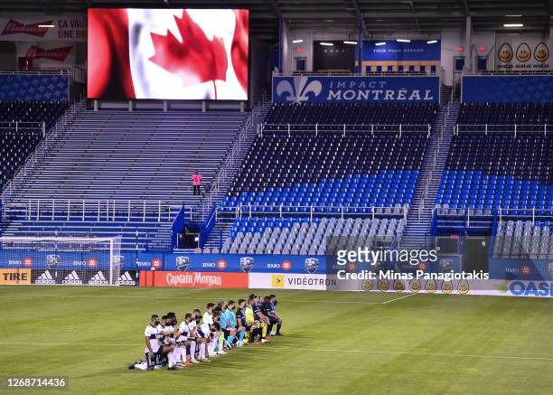 Players from the Vancouver Whitecaps and the Montreal Impact kneel during the pre-game ceremony at Saputo Stadium on August 25, 2020 in Montreal,...