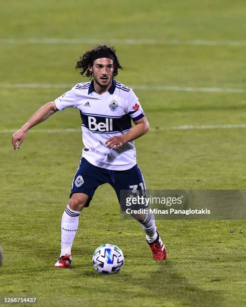 Russell Teibert of the Vancouver Whitecaps controls the ball against the Montreal Impact during the second half of the MLS game at Saputo Stadium on...