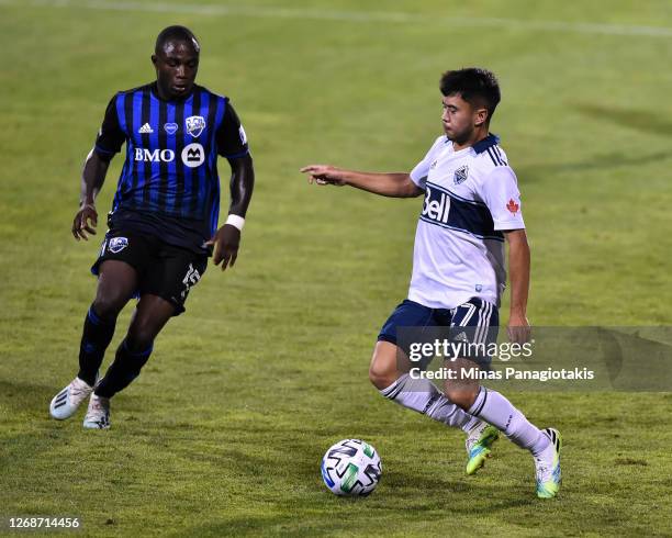 Ryan Raposo of the Vancouver Whitecaps controls the ball against Zachary Brault-Guillard of the Montreal Impact during the second half of the MLS...