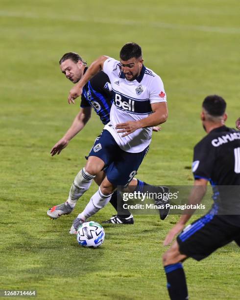 Lucas Cavallini of the Vancouver Whitecaps controls the ball against Samuel Piette of the Montreal Impact during the second half of the MLS game at...