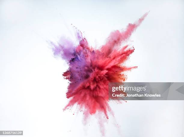purple and red powder explosion - explosion fotografías e imágenes de stock