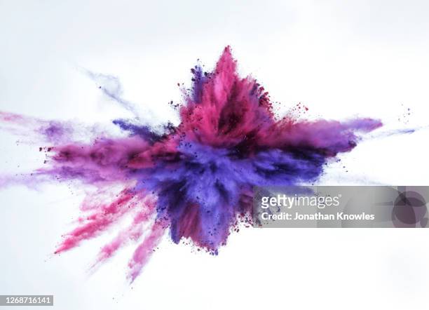 vibrant purple powder explosion - color image stock-fotos und bilder