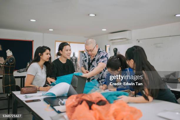 college fashion student attending class in the classroom working on their fashion design - textile manufacturing stock pictures, royalty-free photos & images