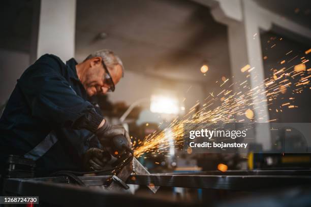 senior man using electric grinder in workshop - grinding stock pictures, royalty-free photos & images