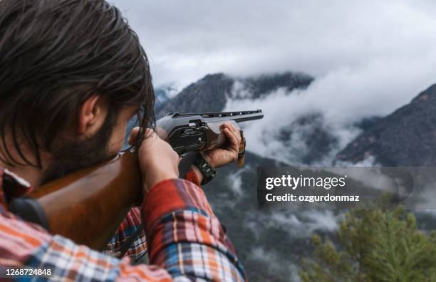 male hunter looking for deer on the mountain - turkey hunting stock pictures, royalty-free photos & images