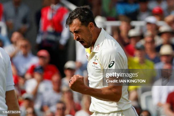 Australia's Mitchell Starc celebrates after taking the wicket of England's Joe Root on day two of the second Ashes cricket Test match between England...