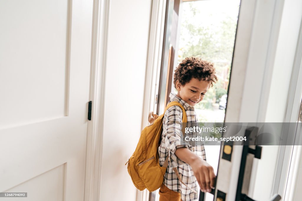 Little student closing door behind himself
