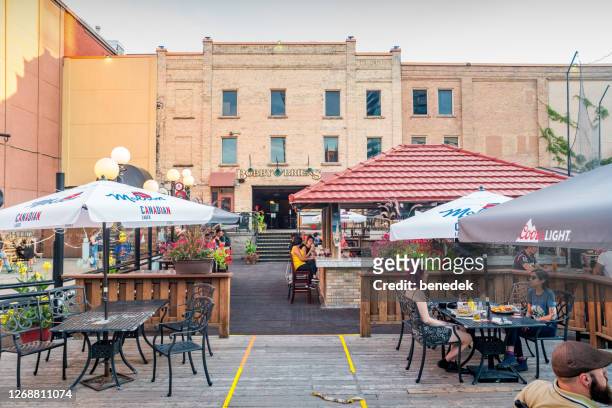 people dine on restaurant pub patio in downtown kitchener ontario canada - kitchener canada stock pictures, royalty-free photos & images