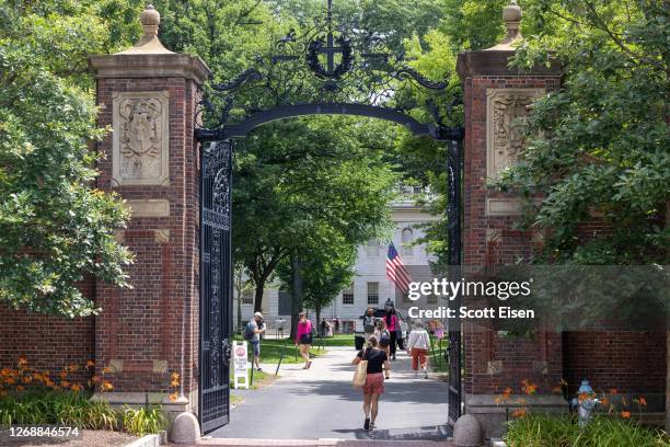 People walk through the gate on Harvard Yard at the Harvard University campus on June 29, 2023 in Cambridge, Massachusetts. The U.S. Supreme Court...